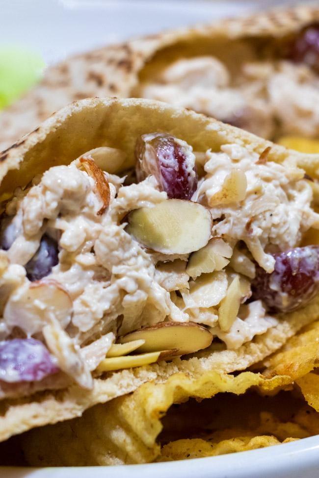 chicken salad pita sandwich with grapes and sliced almonds