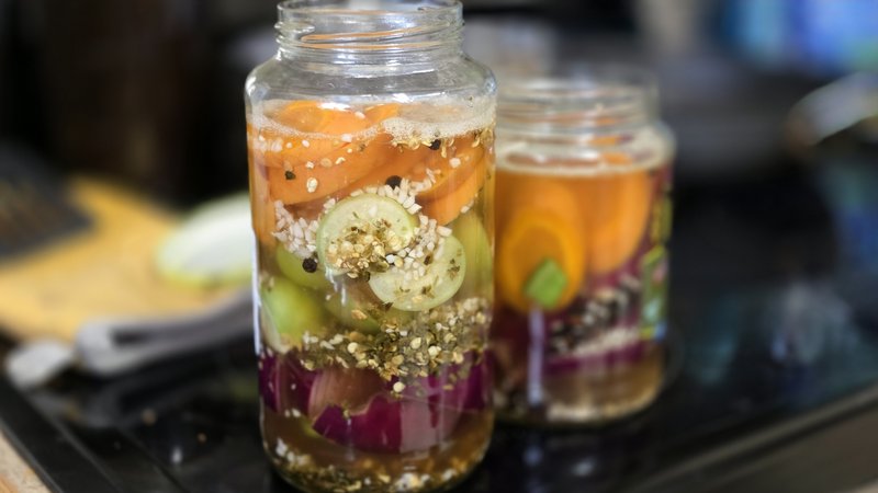 homemade refrigerator vinegar pickles with carrots and red onion in glass jars