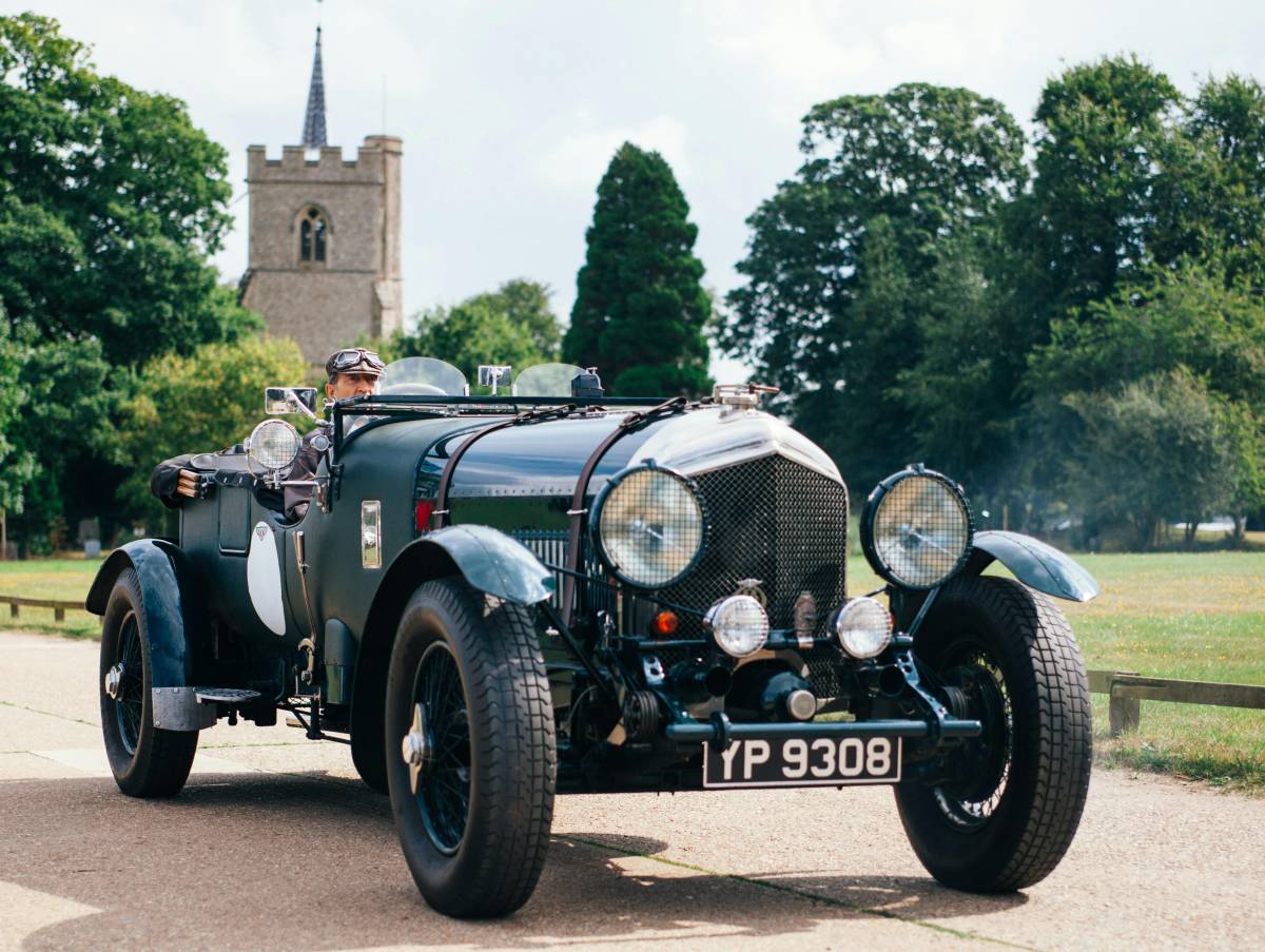 man driving classic car he restored