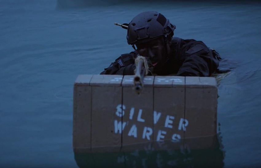 time warrior sniper rifle on box in water