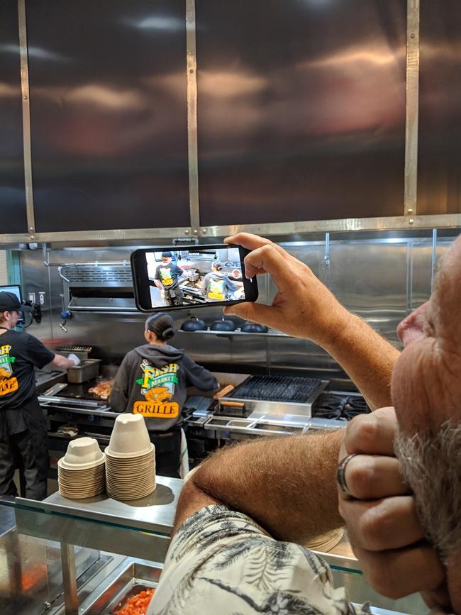 greg from suburban men recording video of san pedro fish market grille