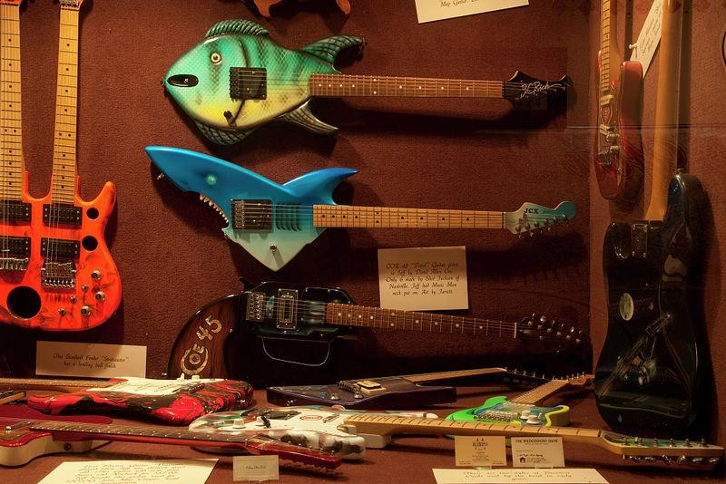 Display of guitars and clothing related to Alabama, a Grammy Award-winning country music and southern rock band that originated in Fort Payne, Alabama