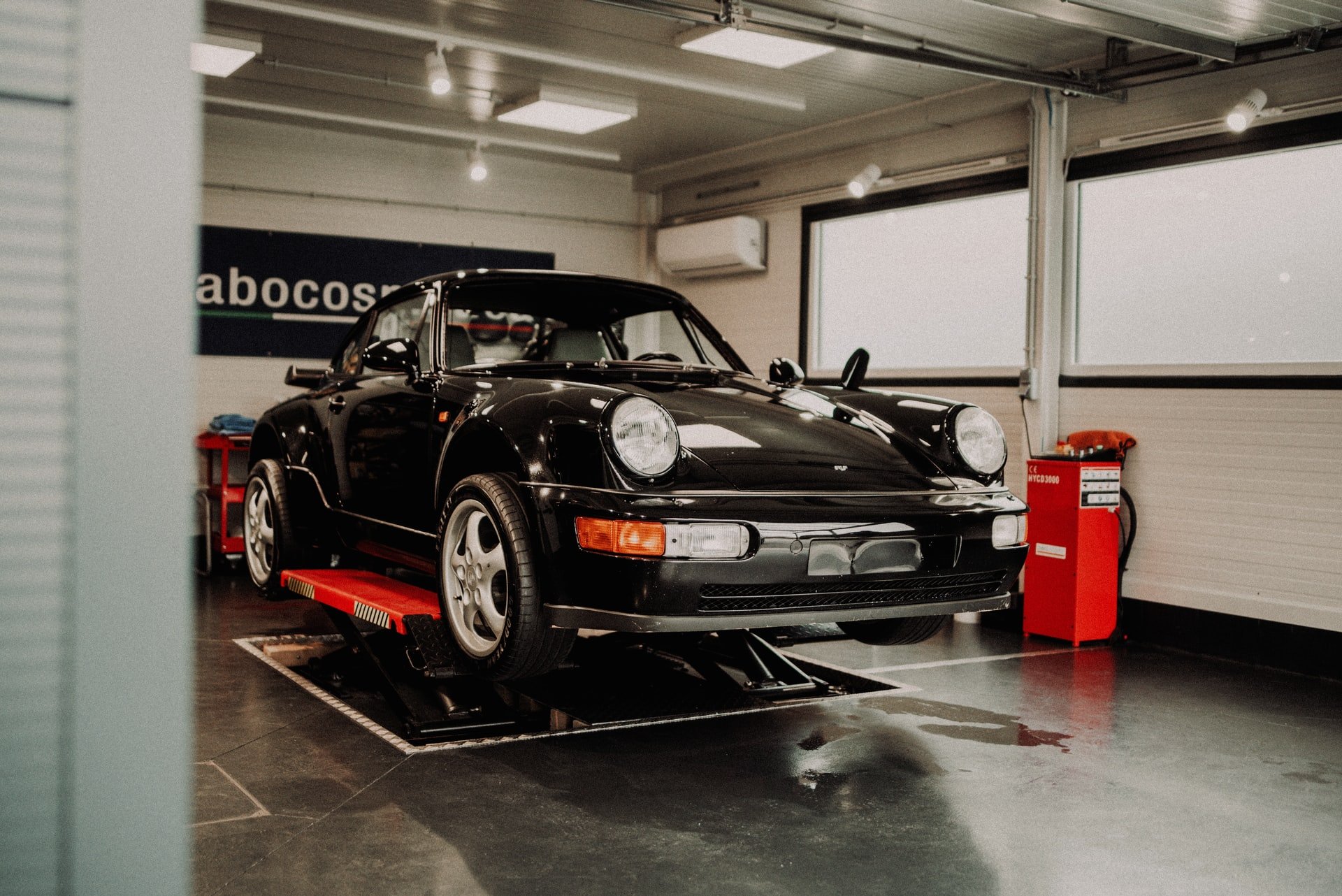Porsche on a lift in the garage