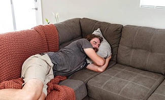 man frustrated by inability to sleep