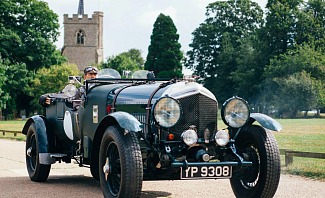 man driving classic car he restored