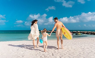 Family beach scene at Embassy Suites by Hilton Aruba Resort