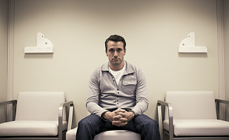 man sitting in a fertility clinic