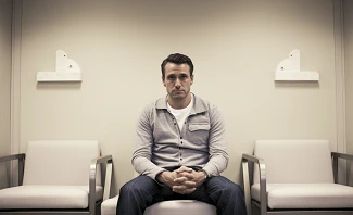 man sitting in a fertility clinic