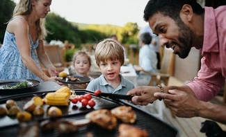 kids and dad are grilling safely